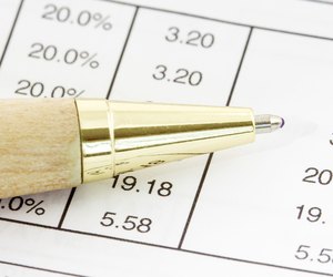 Pen on the financial spreadsheet