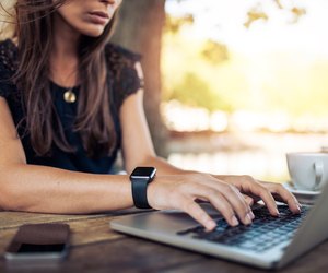 Woman working on laptop in a cafe