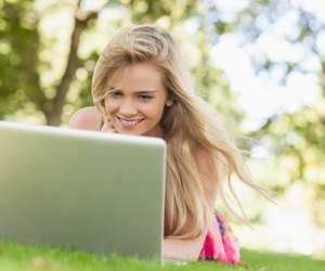 Happy blonde woman working with her notebook
