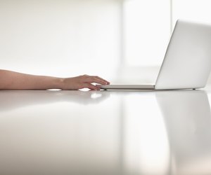 Close up of businesswoman's arm using her laptop in the office