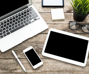 Grunge hipster wooden desktop with computer, digital tablet