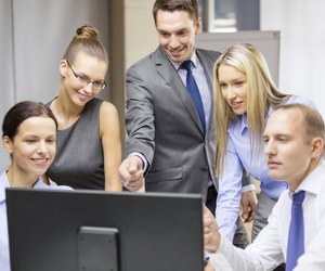 business team with monitor having discussion