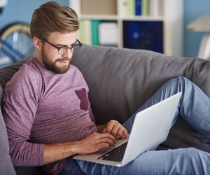 Stylish man using laptop at home