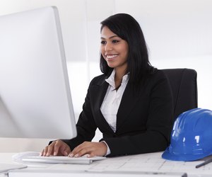 Happy Female Architect Using Computer