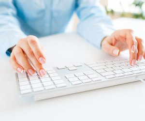 Woman office worker typing on the keyboard