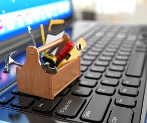 Online support. Toolbox with tools on laptop.