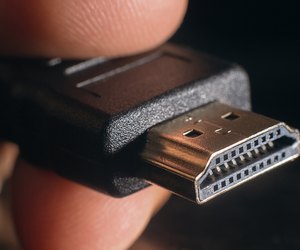 Hand holding black HDMI cable. Closeup HDMI cable.