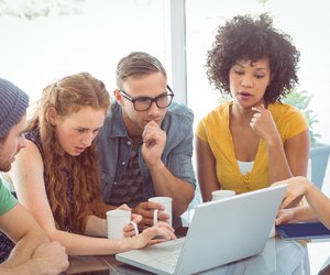 Group of students around a laptop