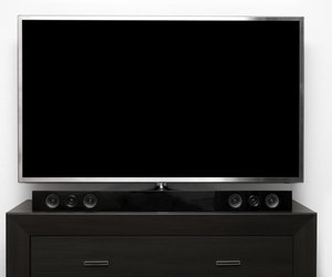 blank tv with stereo system on brown commode
