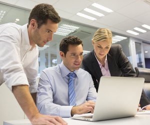 Business team of three in office and planning work