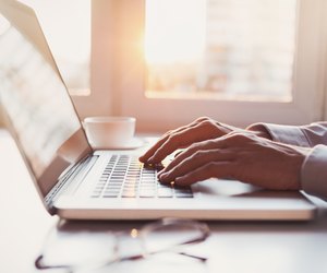 Place of work, man using laptop computer