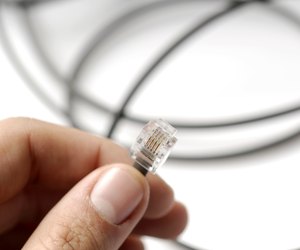 Hand holding internet connection plug, close-up