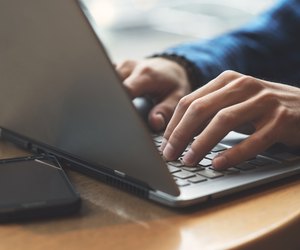 Business mans hands typing on laptop