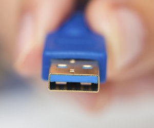 Man's hand holds cable