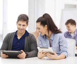 students looking at tablet pc on lecture in school