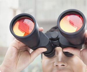 Close Up of Businessman Using Binoculars, Reflection