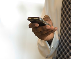 Executive using Blackberry PDA smart phone.