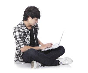 young man sitting on the floor with laptop