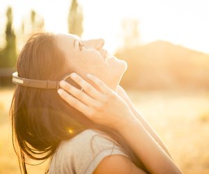 Young happy woman with ear phone