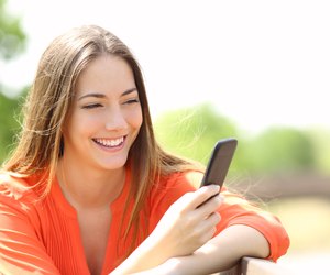 Girl using a smart phone in summer