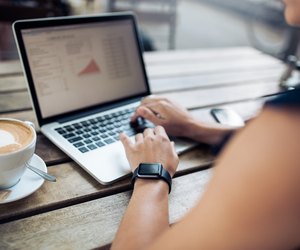 Woman at cafe working on her laptop