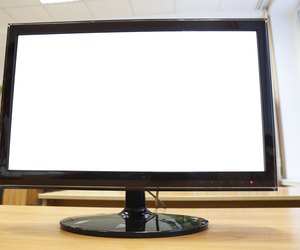 Black monitor with isolated screen standing on an office desk