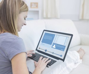 Woman sitting on couch and checking social media profile