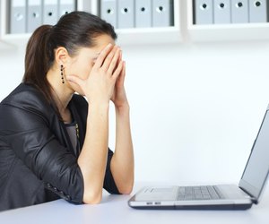 Tired young business woman with laptop