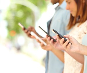 Four friends texting in their smart phones