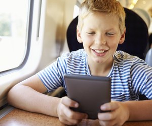 Boy Reading E Book On Train Journey