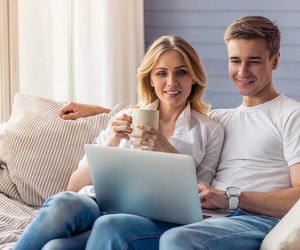Beautiful young couple with gadget