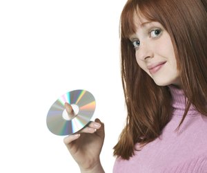 close up shot of a teenage female as she holds up a cd on her finger