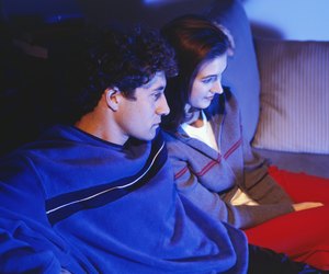 Couple watching television on sofa