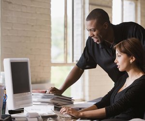 Businesspeople working at desktop computer