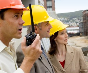 Foreman with architects at construction site