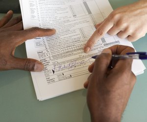 Man signing financial paperwork