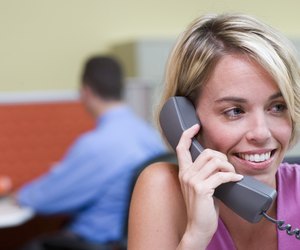 Close-up of a businesswoman talking on a telephone in an office