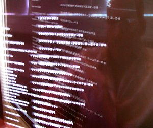 Reflection of programmer in computer monitor