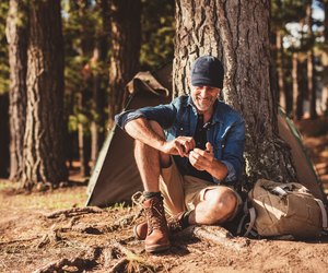 Senior man sitting at campsite