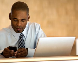 African-american businessman working on PDA.