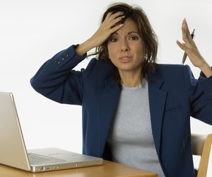 Extremely frustrated businesswoman with laptop