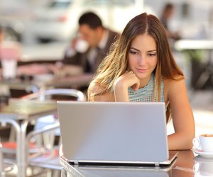 Woman watching media in a laptop in a coffee shop