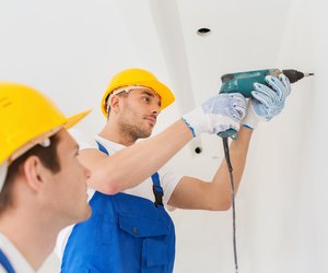 group of builders with drill indoors