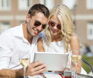 couple looking at tablet pc in cafe
