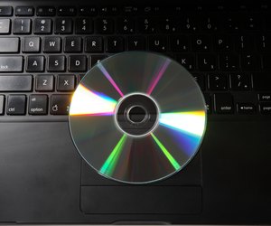 Top angle view of a CD and a laptop