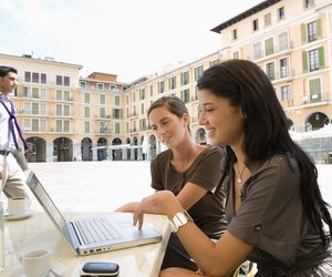 Businesswomen using laptop computer at outdoor cafe