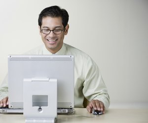 Hispanic man using computer at table