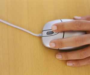 high angle view of a human hand holding a computer mouse