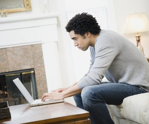African man typing on laptop