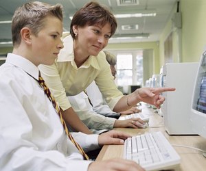 Teacher and student with a computer